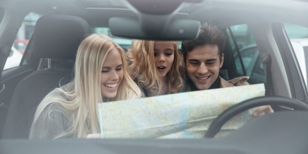 happy-young-family-car-holding-map_171337-5376